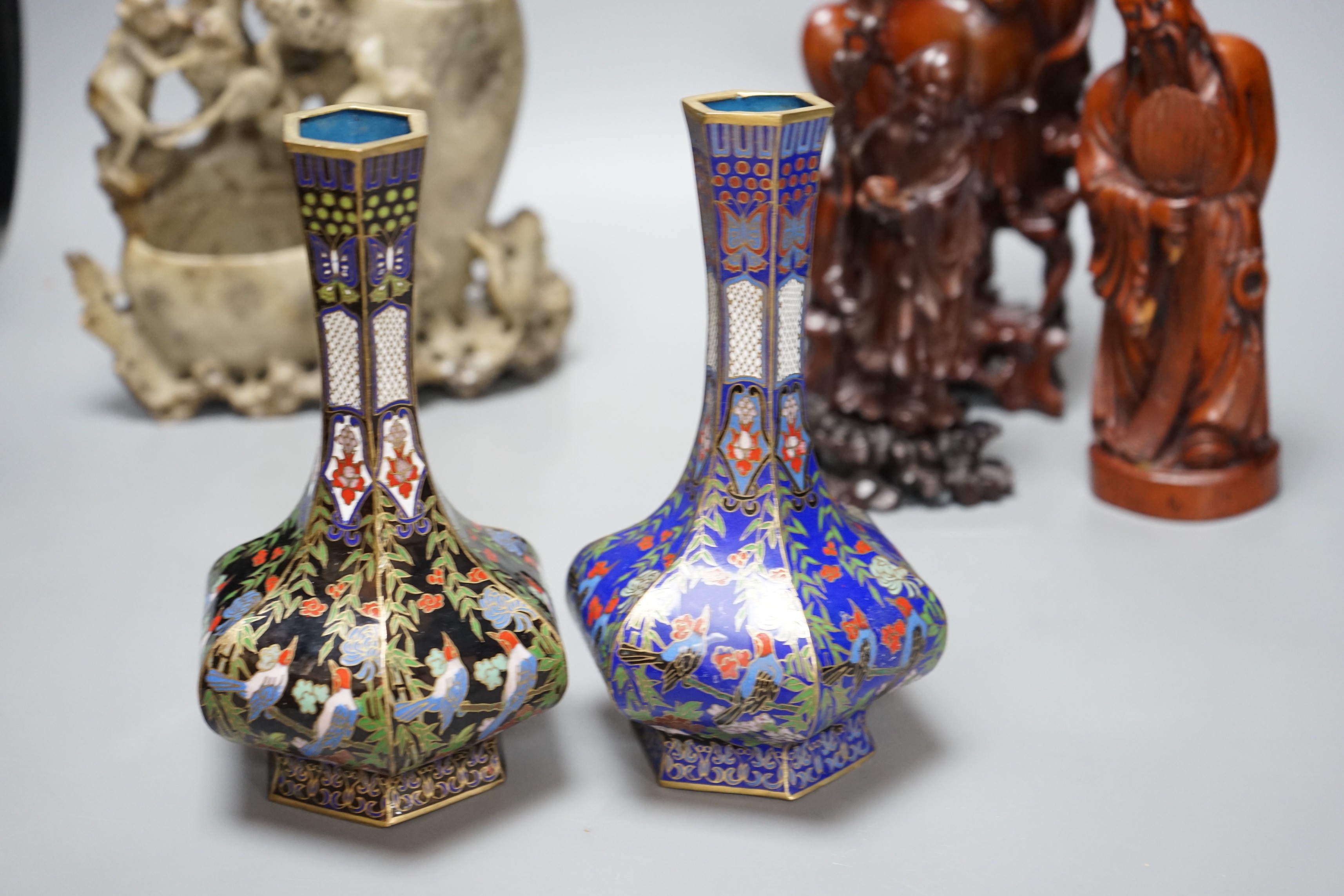 Two Chinese champlevé enamel vases, a soapstone carving and three early 20th century Chinese carved hardwood figures, tallest 26cm